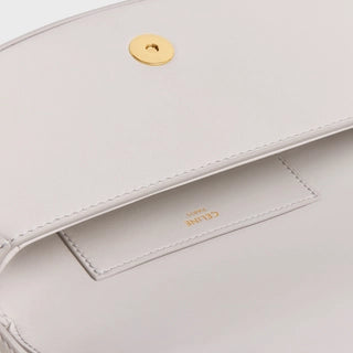 CLUTCH ON STRAP TABOU IN SMOOTH CALFSKIN CHALK